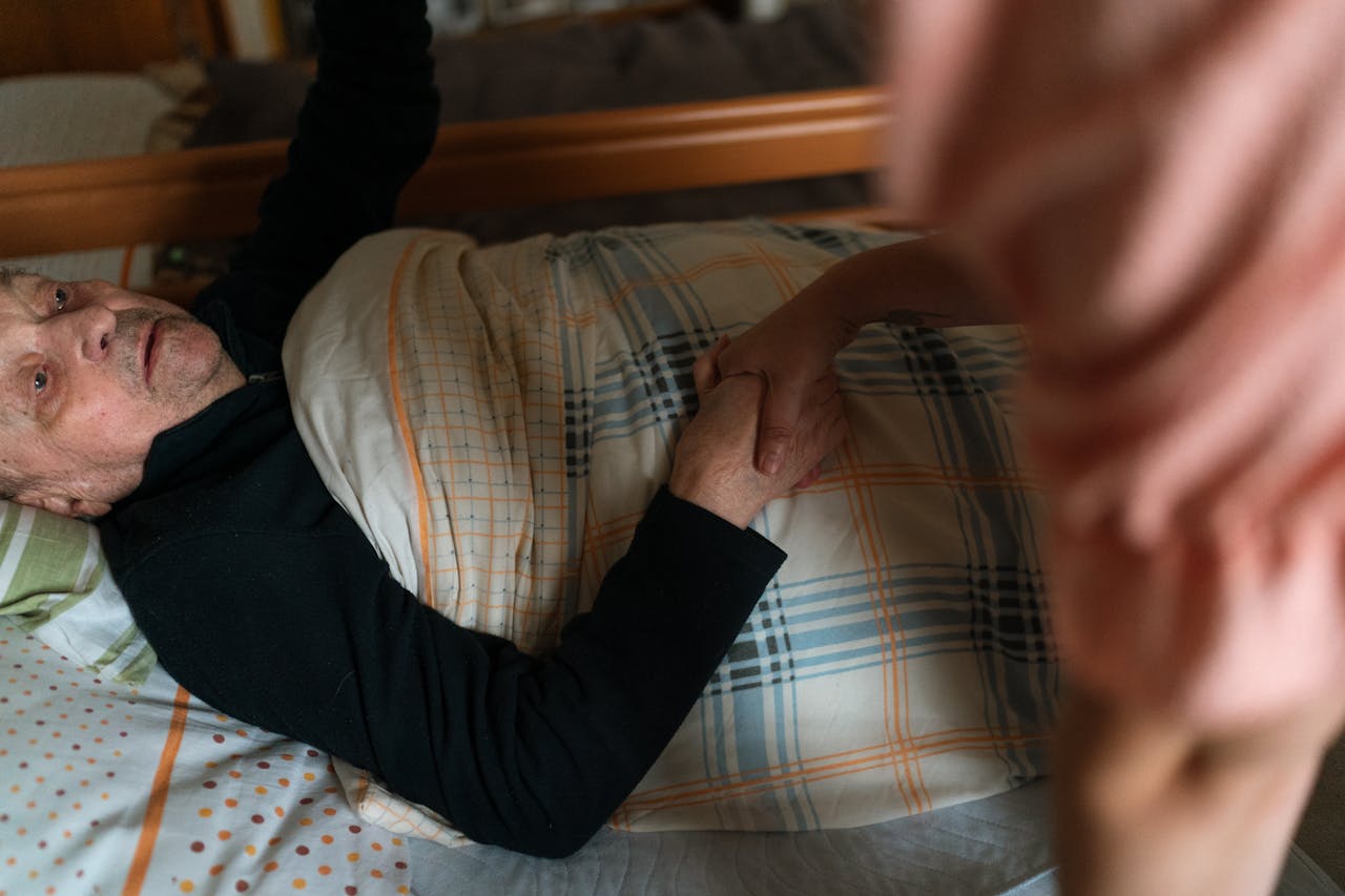 The Art of Drawing Readers In: Your attractive post title goes here A caregiver holding hands with a senior adult, providing support and reassurance at home.